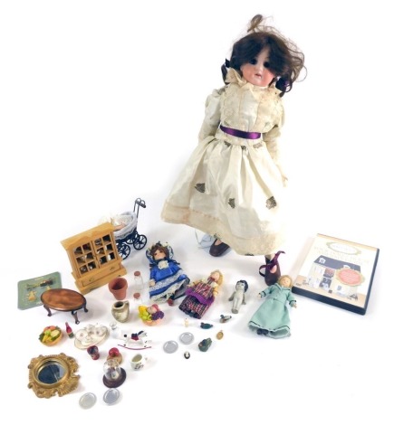 An early 20thC bisque headed doll, with fixed eyes, open mouth showing teeth, with brown hair, on stand with silk finish dress and boots, 39cm high, unmarked, miniature items, miniature dolls, bisque headed and others, etc. (a quantity)