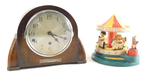 A Corgi Toys Magic Roundabout musical automaton, and an oak cased chiming eight day mantel clock, with 14cm diameter Arabic dial, 13cm high.