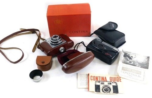 A 20thC Zeiss Icon Contina camera, with Prontor-Svs lens, in brown leather case, 10cm high, in original box and a Halina camera. (2)