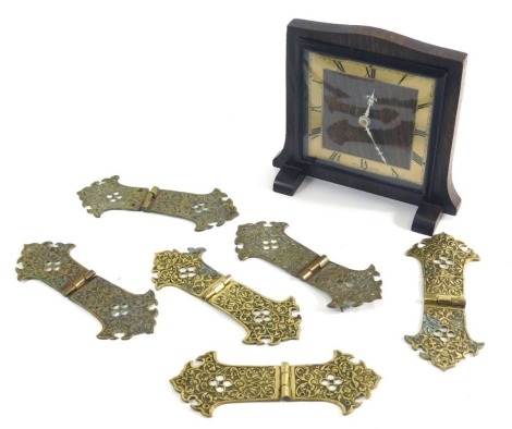 A Smiths Sectric oak cased mantel clock, with Roman numeric dial, and a quantity of elaborate part pierced brass hinges or book clasps, 16cm wide.