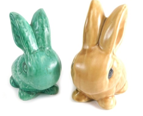 A 20thC Sylvac style pottery rabbit, in green, marked England, 14cm high, and another in brown, number 1026. (2)