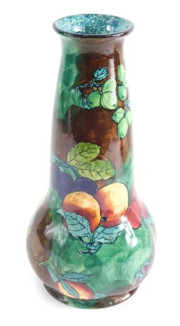 A 20thC FX Abraham, Hancock and Sons pottery vase, decorated with fruit, on a brown and green ground, printed marks beneath, 31cm high.