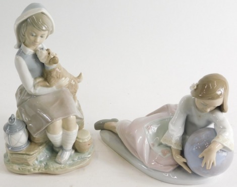 Two Lladro figures, girl aside globe, and another girl aside puppy and lantern, printed marks beneath, 23cm high. (2)