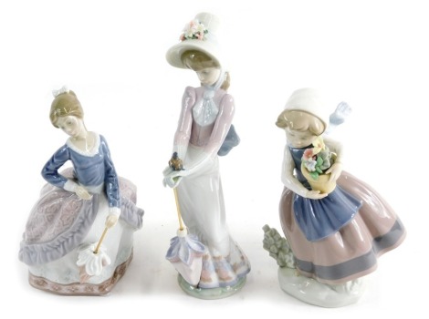 Three various Lladro figures, Garden Song, 07618, 23cm high, and two others, girl holding basket, etc., printed marks beneath. (3)