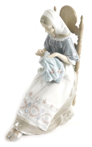 A large Lladro figure, lady sewing, printed marks beneath, 31cm high.