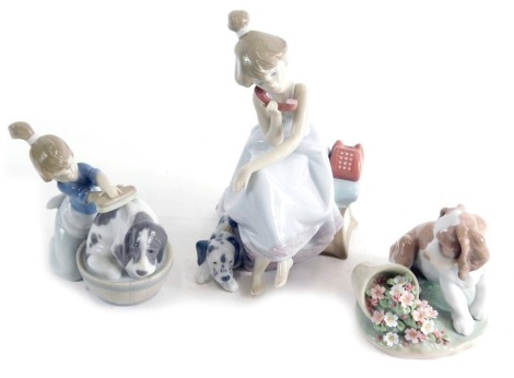 Three various Lladro figures, girl brushing puppy, 5455, 13cm high, and girl and puppy aside telephone, 5466, printed marks beneath. (2, with 1 box)