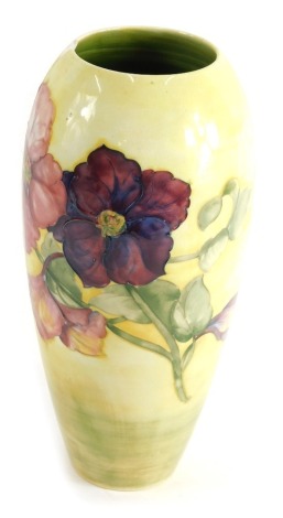 A 20thC Moorcroft pottery vase, on yellow ground, impressed marks beneath, 33cm high. (AF)