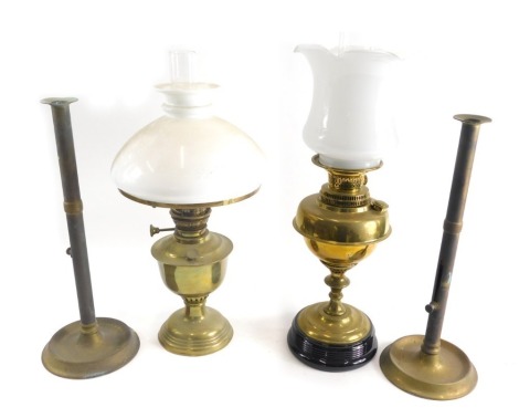 Various brassware, a 20thC oil lamp with clear glass funnel, milk glass shade, brass reservoir, turned stem and socle, 69cm high, a pair of telescopic candlesticks of turned form, and a further oil lamp. (a quantity)