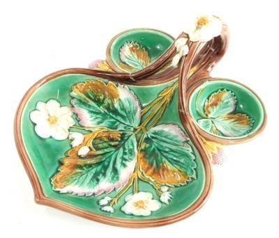 A late 19thC Wedgwood majolica strawberry dish, florally decorated predominately in green, white and brown, floral handle, with diamond registration mark beneath, 20cm wide.