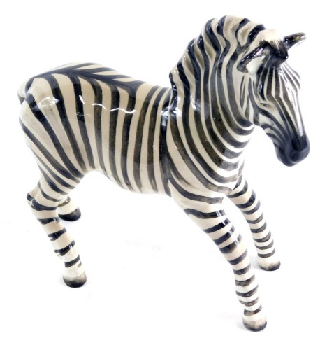 A Beswick pottery figure of a zebra, printed marks beneath, 20cm high.