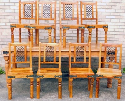 An Eastern hardwood dining room table, the rectangular table with metal embellishments, on turned legs, 78cm high, 216cm wide, 102cm deep, and eight chairs. and a wine rack. (10)