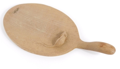 A Robert Thompson of Kilburn Mouseman oak cheeseboard, of oval form with shaped handle, carved with mouse, 37cm long.