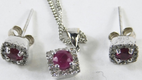 An 18ct white gold ruby and diamond necklace and earring set, with square studs with central emerald, surrounded by tiny diamonds, the pendant same form set as a diamond shape, on curb link neck chain, 52cm long, white metal stamped 750, 7.5g all in, boxe