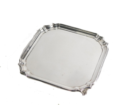 A George VI silver salver, by William Hutton and Sons, with a stepped border, on scroll feet, Sheffield 1943, 31cm wide, 15.5oz.