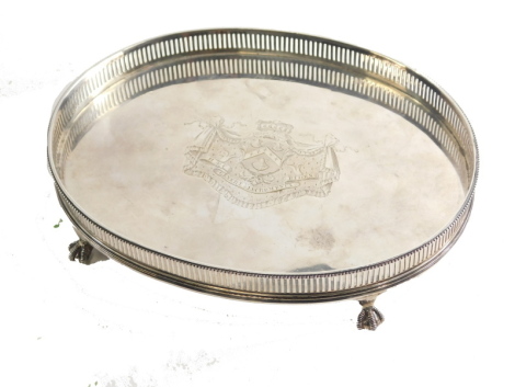 A Charles III silver tray, of oval form with galleried edge, central crest on ball and claw feet, marked 48=10, original hallmarks struck out, London Assay Office marks for 2023, case number 9563, 27cm wide, 23oz.