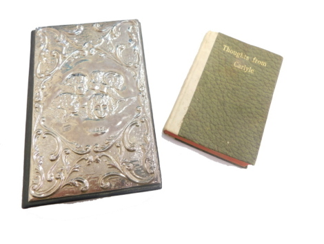 An Elizabeth II silver fronted address book, repousse decorated with cherubs, with scroll surround, London 1990 and a small book Thoughts From Carlyle. (2)