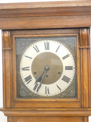 A 20thC oak cased longcase clock, the silvered 22cm diameter chapter ring with Roman numeric dial, with raised scroll, floral and shell spandrels, in a fitted case with glazed front, with diamond carving, on bracket feet, 181cm high. - 2