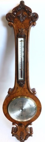 Pastorelli and Co of London. A Victorian walnut wheel barometer, the case carved with scrolls, leaves, etc., with silvered thermometer and dial.