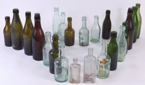 Various early 20thC and other glass bottles, to include Loweson and Cobbold LD Stamford, 26cm high, a quantity of others, clear glass, brown glass, etc. (a quantity)