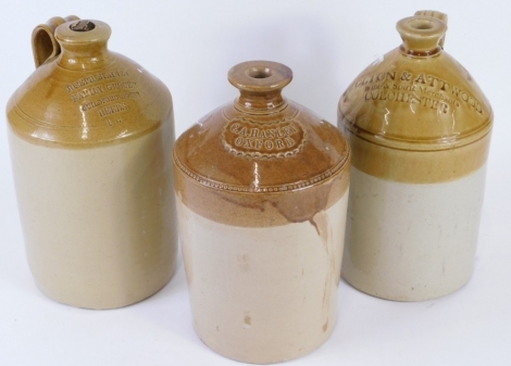 Three various stoneware flagons, to include Joseph Staines Family Grocer, Guildford House Leeds, with part cork stopper, 38cm high, another C. A. Hanley Oxford jar, with rosette label, and a further flagon. (3)