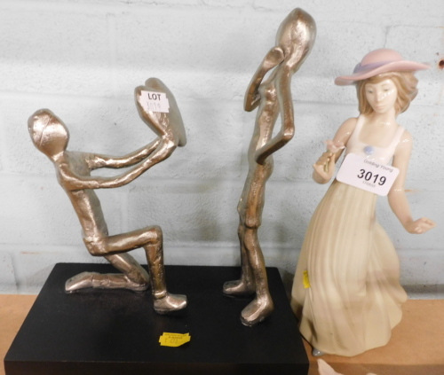 A Nao figure of a lady, and a figure group proposing figure before another.