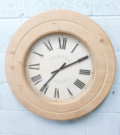 A modern pine cased Tempus Fugit battery operated wall clock, with Roman numeric dial and baton pointers, battery operated, 76cm diameter.