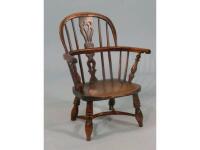 A mid 19thC yew ash and elm child's windsor armchair with a solid