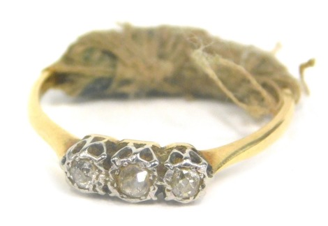 A dress ring, illusion set with three small white stone, unmarked, size N.