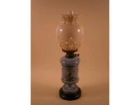 A Victorian purple glass oil lamp decorated with birds and flowers