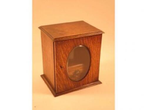 An early 20thC oak smokers cabinet