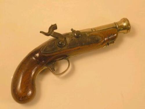 A pistol with a brass barrel and walnut stock