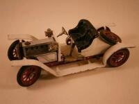 A Mamod steam driven model of a vintage car painted in cream and red