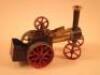 A Mamod model of a vintage traction engine painted in black