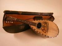 A Neapolitan mandolin with simulated tortoiseshell and mother of pearl decoration