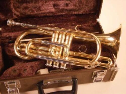 A brass Yamaha cornet with various fittings