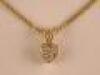 An 18ct gold fine chain with tiny diamond set heart shaped pendant<br