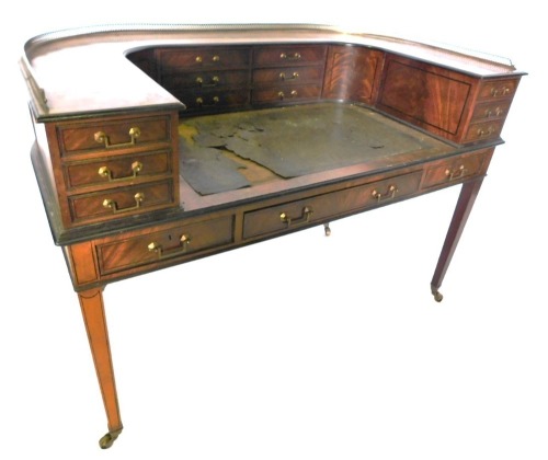 A late 19thC mahogany and ebonised Carlton House desk, the raised top with a pierced brass gallery and an arrangement of twelve drawers and two ebony strung doors, the base with a green leather inset above three frieze drawers each with brass drop handles