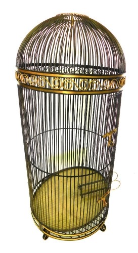 A patinated brass and gilt large parrot cage, with scroll frieze, plain sides, and a galleried tray to interior, on scroll feet, 173cm high, 74cm diameter.