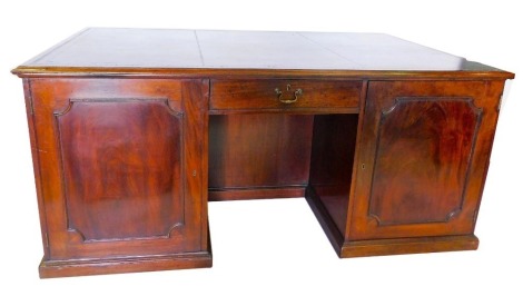 A 19thC mahogany partner's kneehole desk, the rectangular top with a black tooled leather inset and a moulded edge, above an arrangement of one drawer and two panelled doors to each side, on a plinth, 83cm high, 189cm wide, 118cm deep.