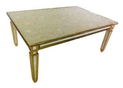 A Continental giltwood and mirrored coffee table, the rectangular top inset with floral silk, with a plain frieze, on square tapering legs, lacking glass, 50cm high, 117cm wide, 81cm deep.
