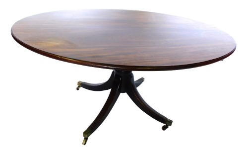 A George III mahogany breakfast table, the oval with a moulded edge, on a turned column, and four splayed legs, with brass castors, 71cm high, 138cm wide, 113cm deep.