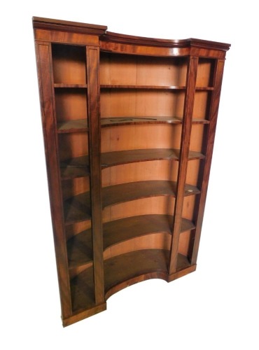 An unusual 19thC mahogany and ebony strung alcove bookcase, with a moulded cornice above six concave shelves, on a plinth, 183cm high, 122cm wide.