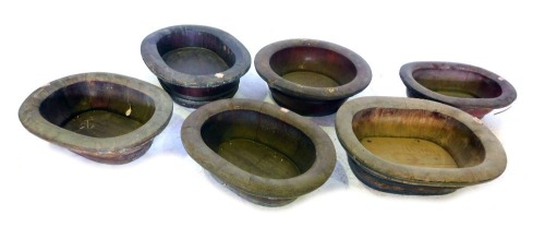 A collection of six brass bound treen jardinieres, comprising five oblong and one circular, in various sizes, no liners.