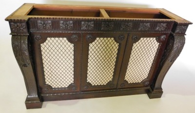 A mahogany side cabinet, with an inverted breakfront frieze carved with flutes, leaf patera, etc., above three doors each with brass grills, flanked by leaf carved brackets, on a plinth, lacking top, 104cm high, 162cm wide. (AF) - 2