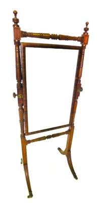 A mahogany and ebony strung cheval mirror, the rectangular mirror plate on turned supports, on sabre legs, with brass castors, 167cm high, 67cm wide.