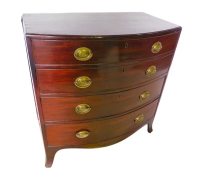 A mid 19thC mahogany bow fronted chest of drawers, the top with a moulded edge, above four graduated drawers, each with oval brass handles, on splayed feet, 96cm high, 92cm wide, 52cm deep.