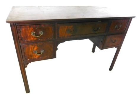 A late 19th/early 20thC mahogany kneehole dressing table, the rectangular top above an arrangement of five drawers, each with drop handles, on channelled legs with pierced brackets, 81cm high, 122cm wide, 55cm deep.