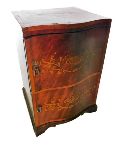 A 19thC mahogany marquetry pedestal or bedside cabinet, the serpentine fronted top decorated with a large urn, above two doors, each with oval patera, leaves, etc., on bracket feet, 72cm high, 45cm wide, 43cm deep.