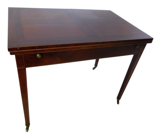 A mahogany and boxwood strung draw leaf dining table, the rectangular figured top above a plain frieze, on square tapering legs, with brass castors, 74cm high, 92cm wide, 119cm long.