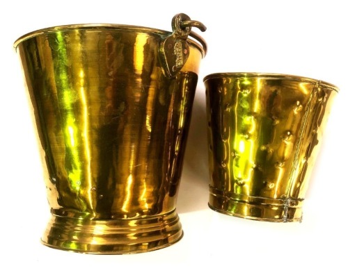 A 19thC brass coal bucket, with loop handle, of tapering form, with plinth, 28cm high, and a brass waste paper bin, 20cm high.